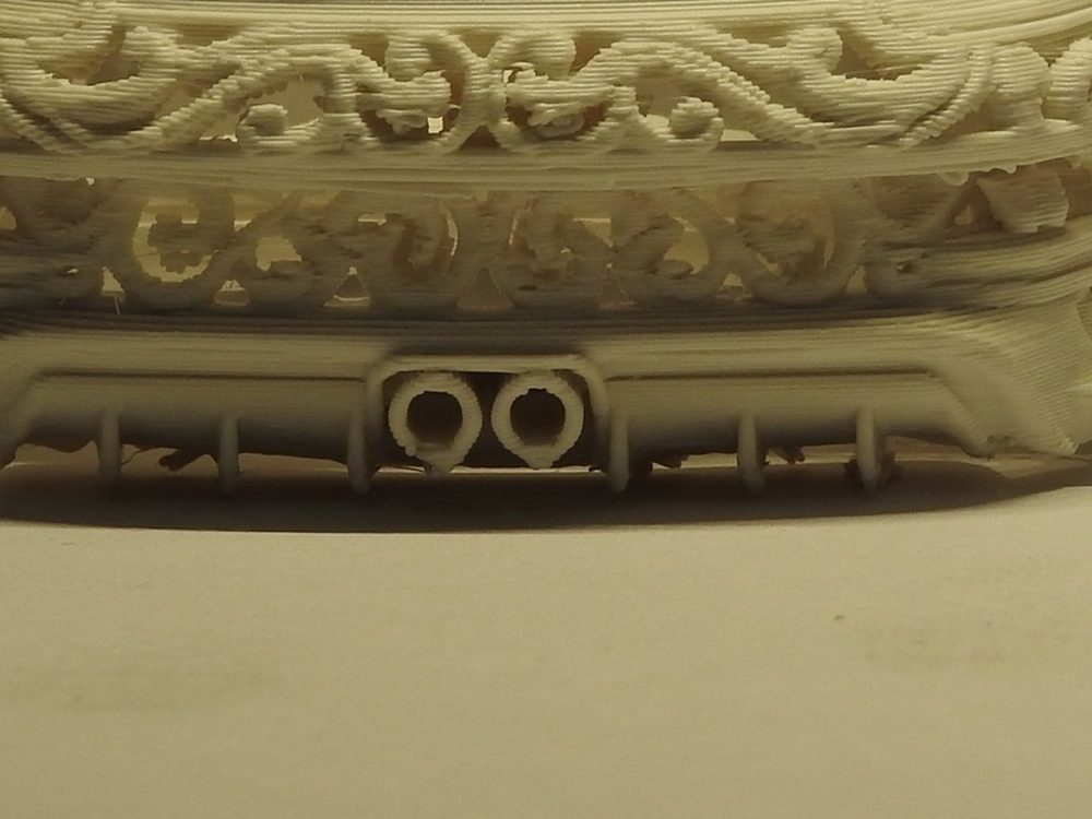 Close up of the rear of the printed GT3, showing twin round exhaust tips in a finned diffuser below layers of ornamental openwork
